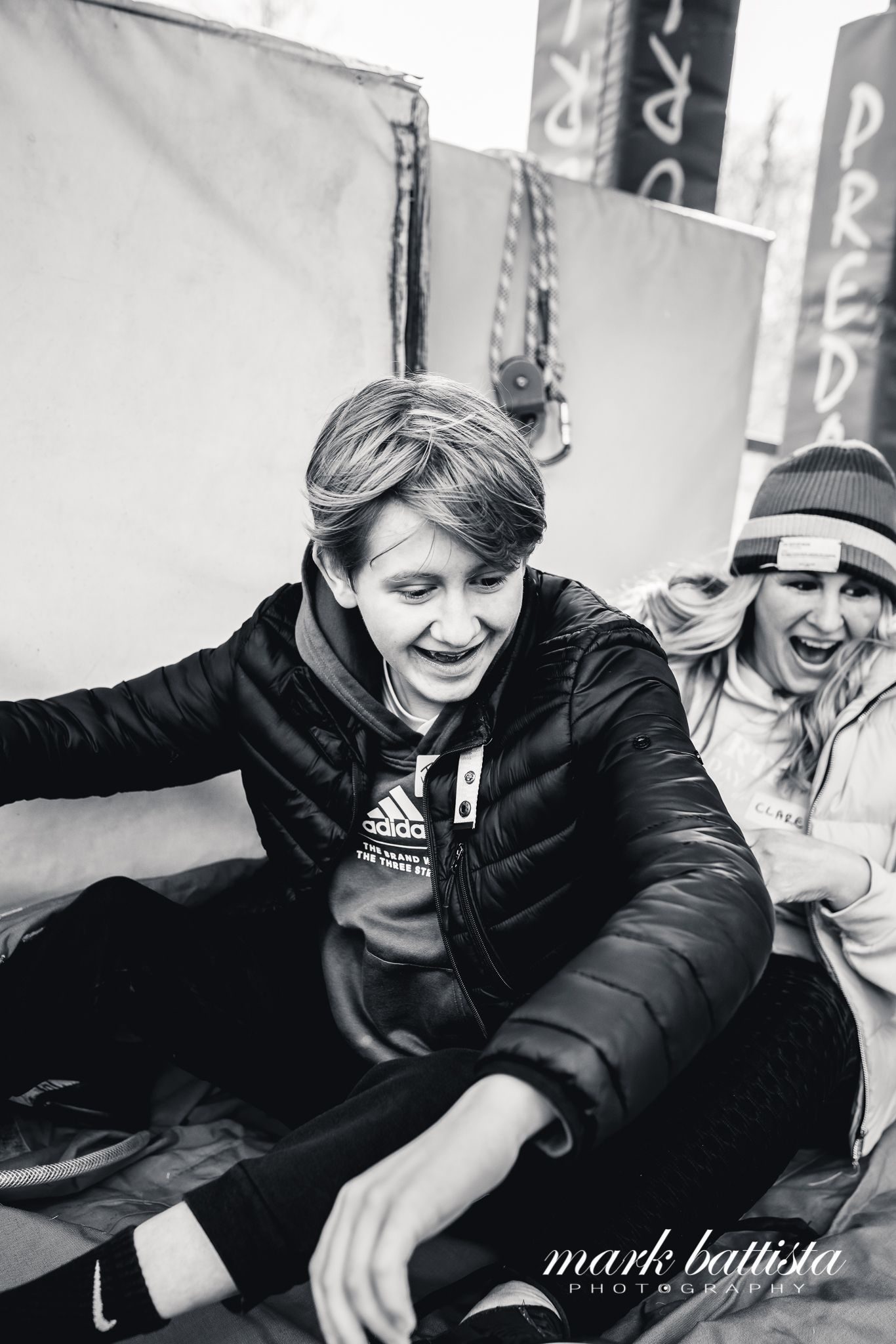 Black and white candid shot of people enjoying themselves at an outdoor event.