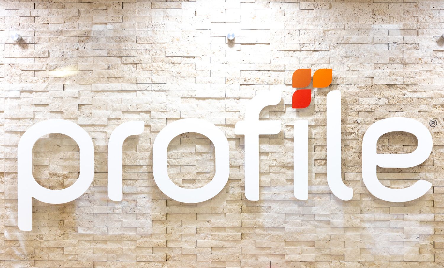 Modern office interior with white brick wall and minimalist text signage.