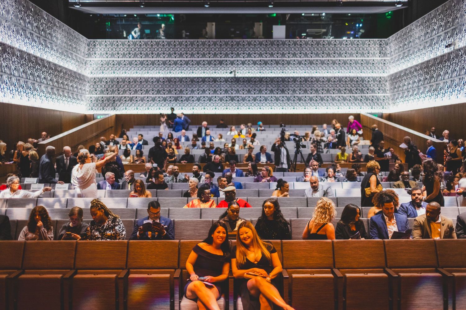 Guests waiting in theater seats inside NMAAHC Oprah Winfrey Theater