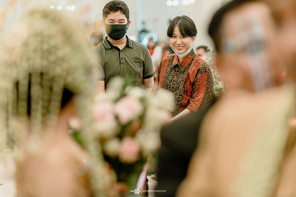 Event guests interact during a celebration while wearing face masks.