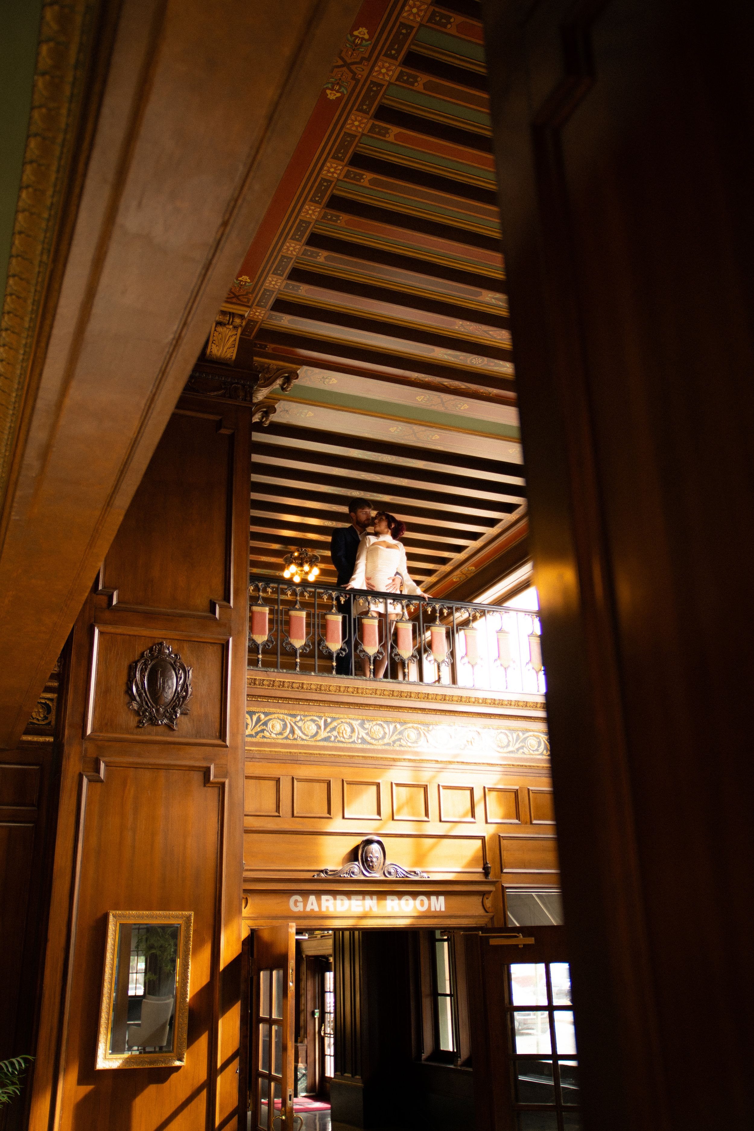 Interior architectural details of an elegant wood-paneled room with beamed ceilings.
