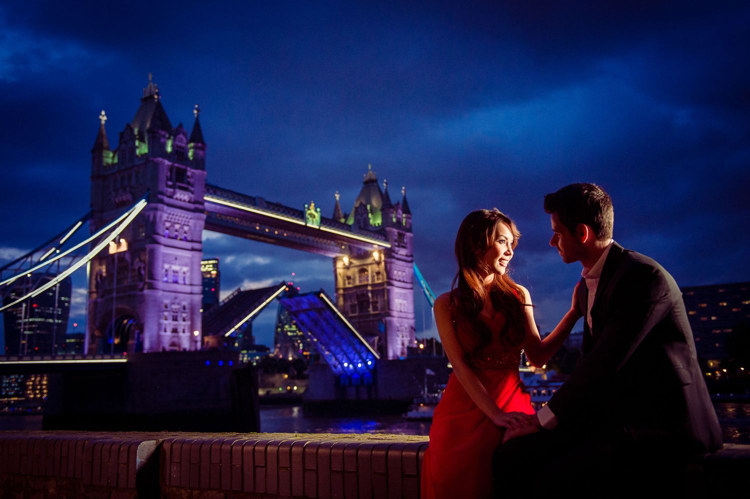 Pre-wedding couple at dusk with Tower Bridge behind them