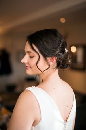 An elegant bridal portrait showing intricate updo hairstyling.