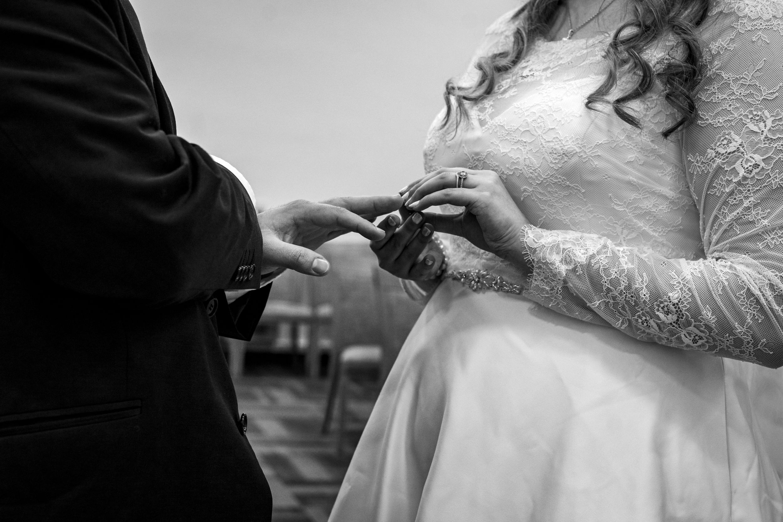 Close-up black and white wedding photography sequence showing romantic moments between newlyweds.