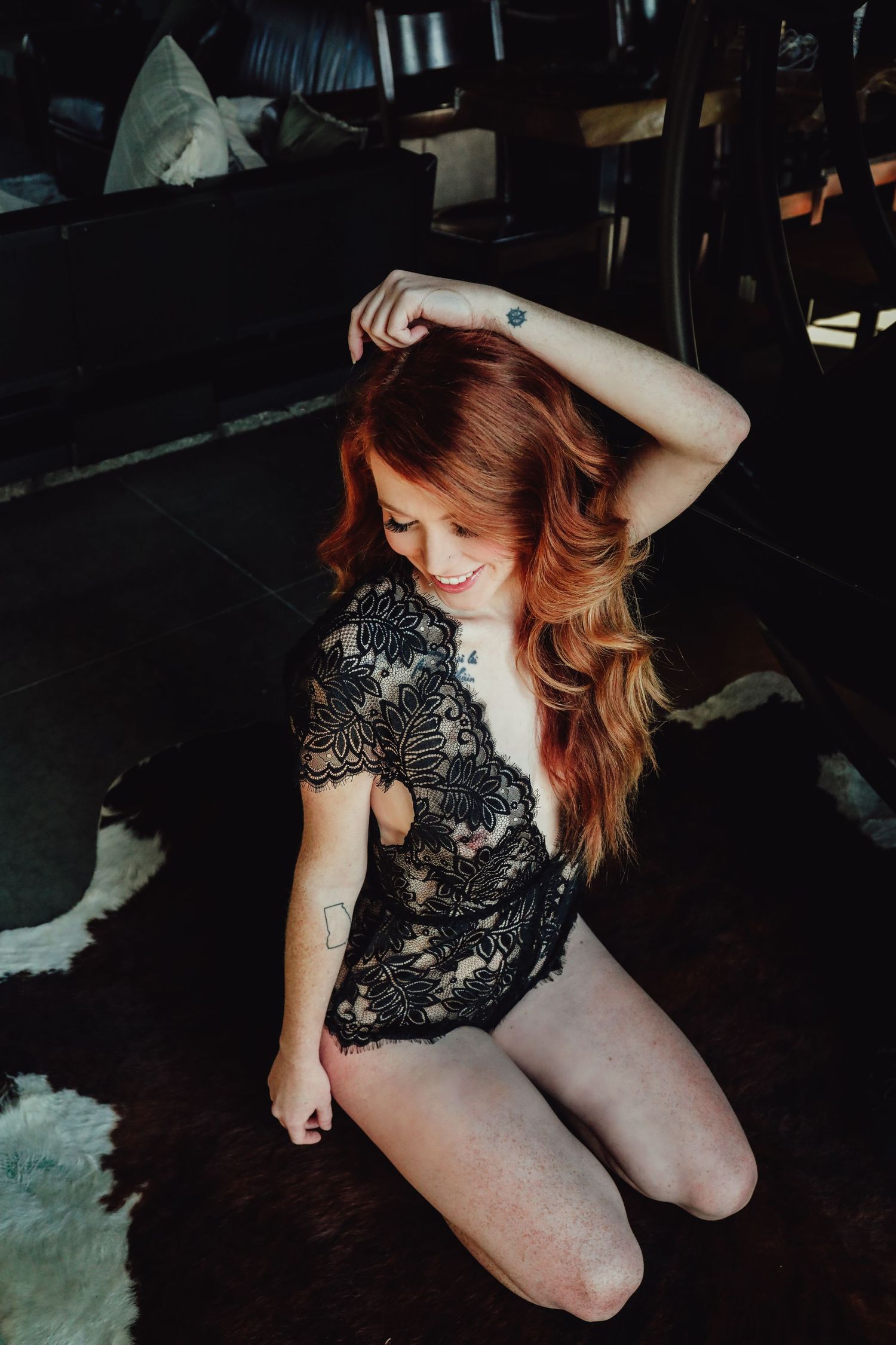 Artistic boudoir photos featuring black lace lingerie in low-light setting.