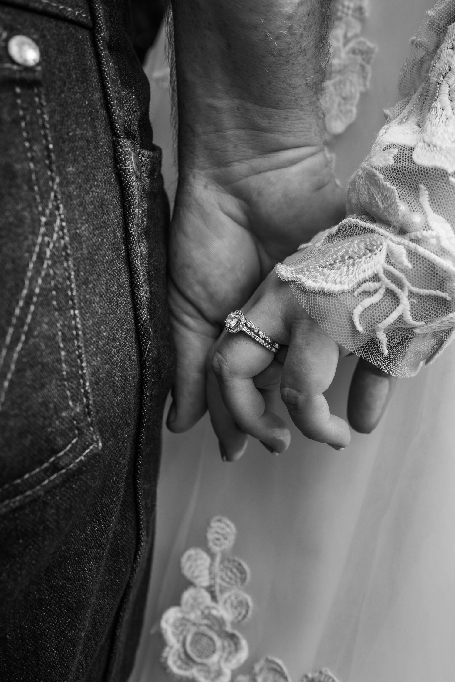 Close-up black and white photos of hands with wedding rings and lace details.