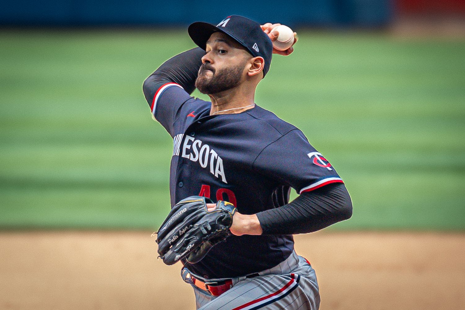 Pablo López, the pitcher for the Minnesota Twins, is in full action, delivering the pitch.