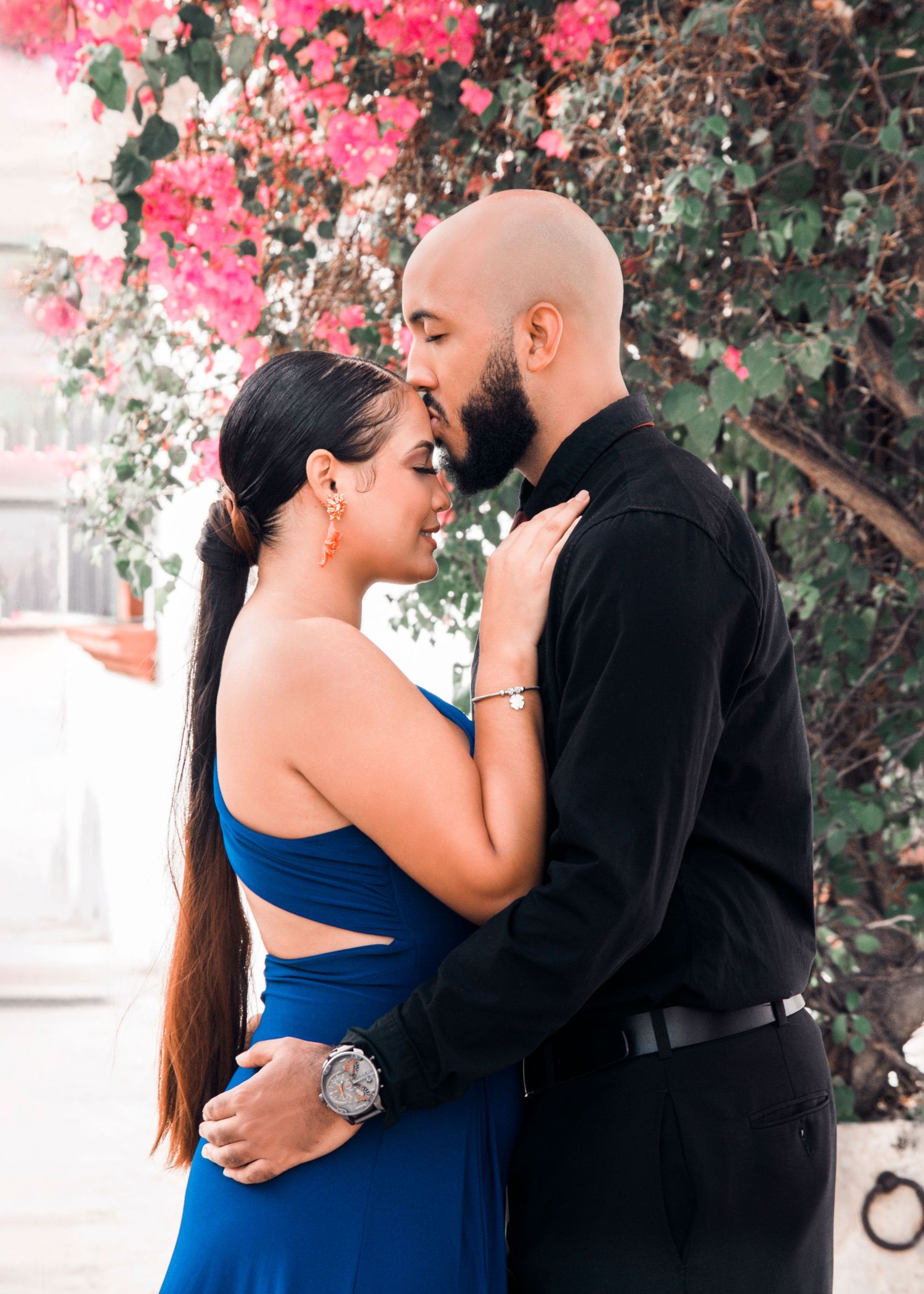 Couples photoshoot in Allentown PA of romantic couple embracing outdoors with flowers background.