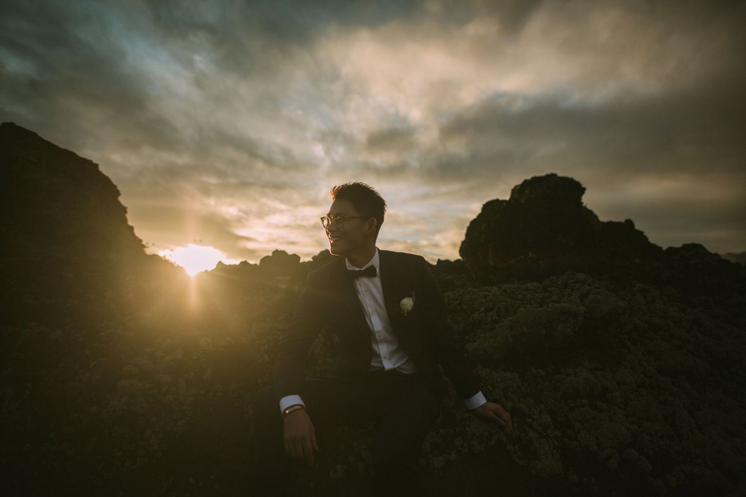 Romantic sunset photoshoot with couple among dramatic rock formations.