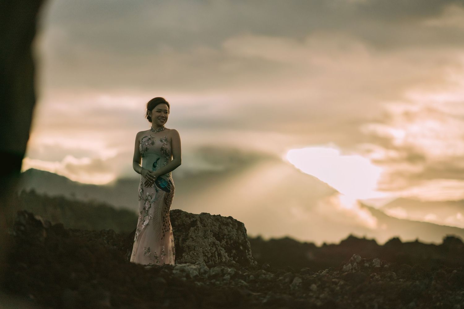 Dramatic wedding photography session during sunset with mountain backdrop.
