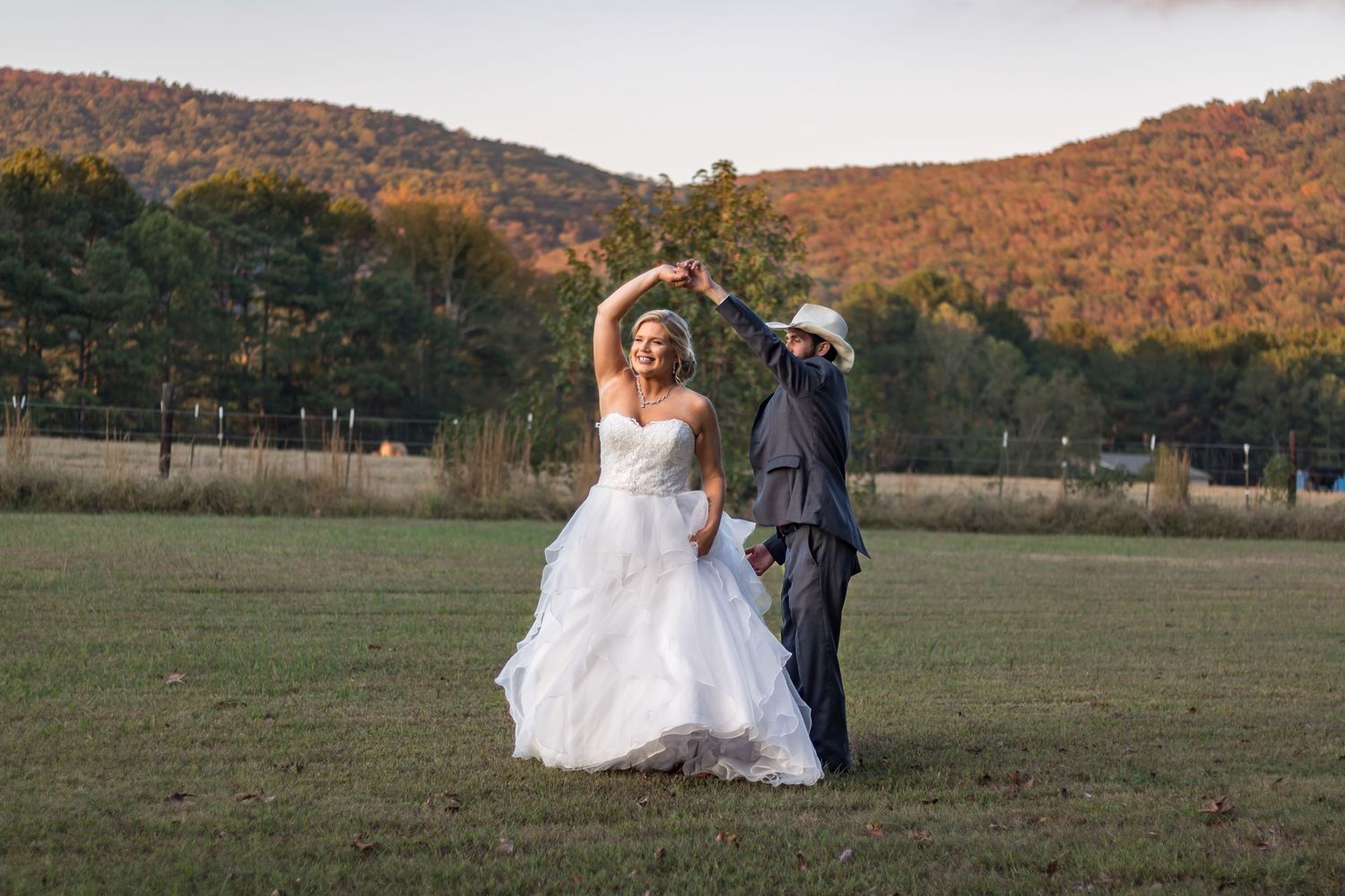 Autumn wedding photo with mountains and fall foliage in background.