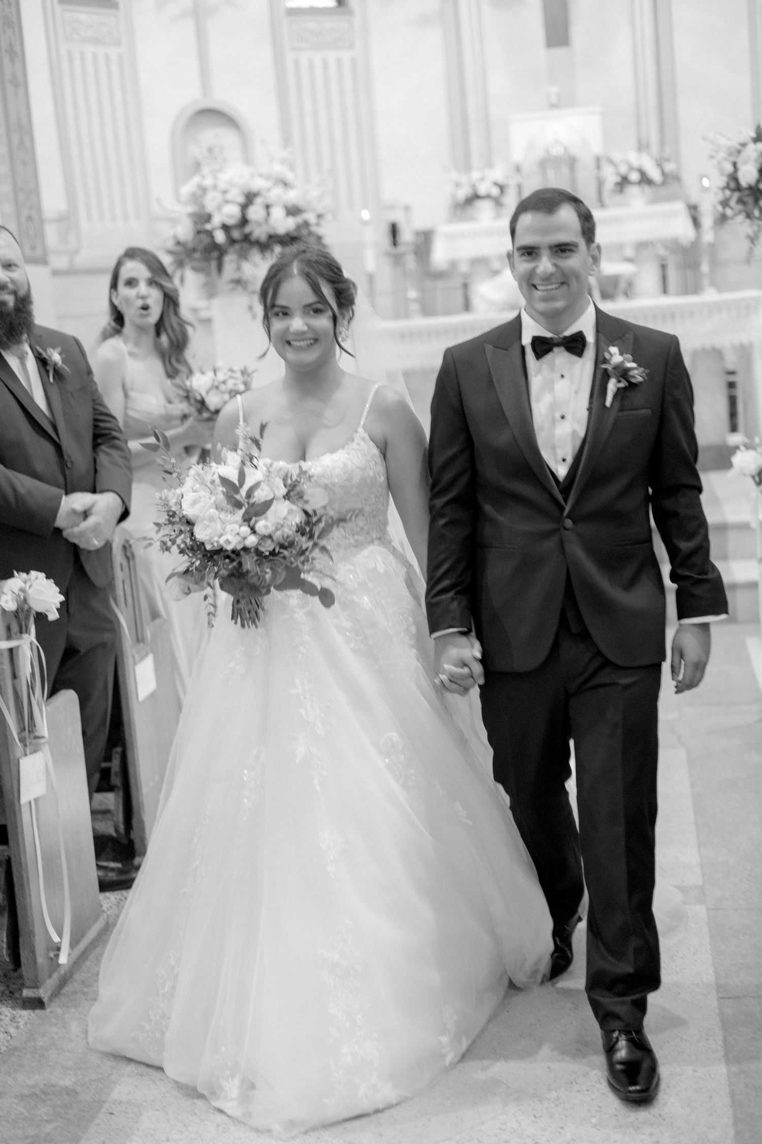 Newlyweds walking down the church aisle after their wedding ceremony.