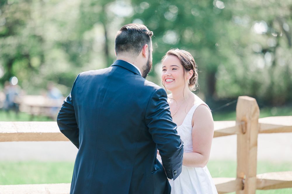A couple shares an intimate moment during their outdoor wedding ceremony.