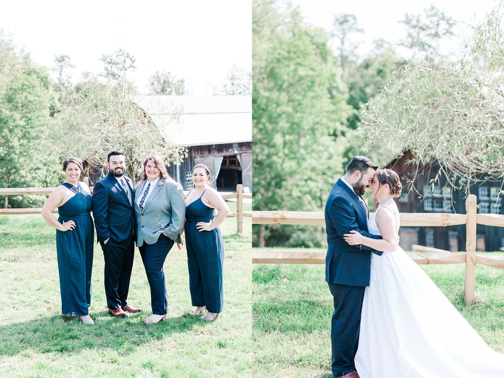 Wedding party poses in navy blue attire next to wooden fencing at rustic outdoor venue.