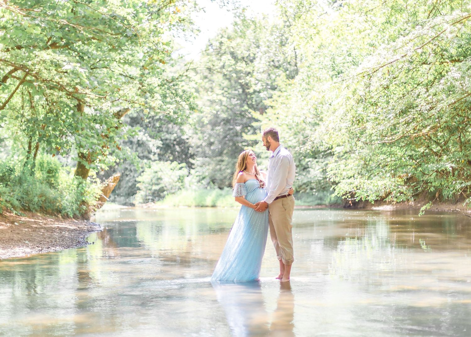 pregnant couple in shallow stream, sarasota maternity photo, lakewood ranch baby photography, siesta key family photoshoot, nokomis vacation