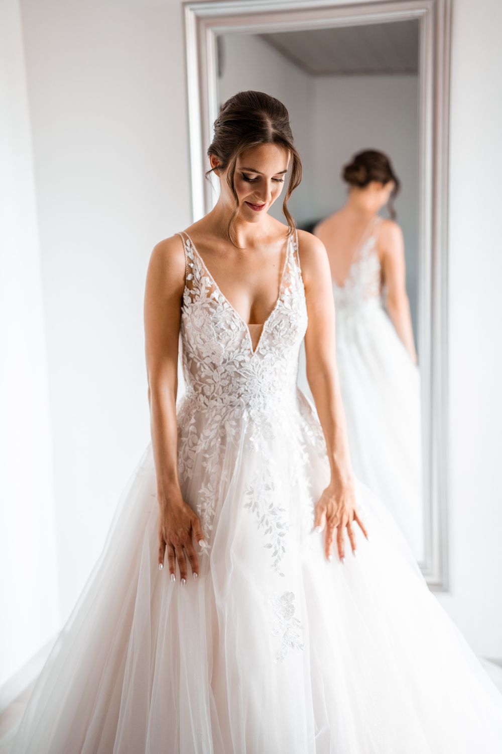 Wedding gown featuring delicate lace bodice and flowing tulle skirt.
