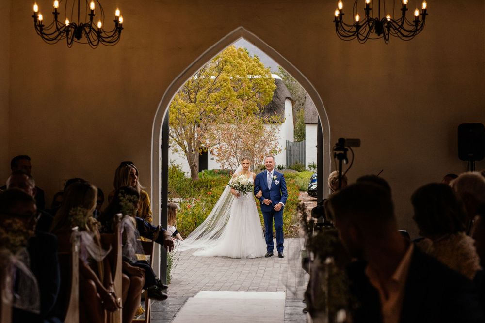 grooms pov of the bride coming down the aisle at Erinvale
