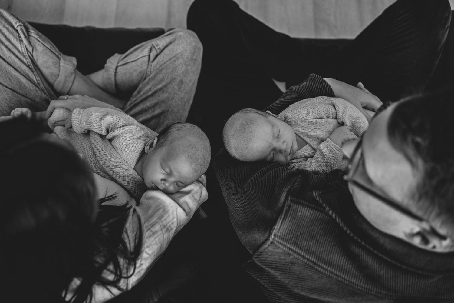 Black and white photograph of sleeping infants with caregiver.