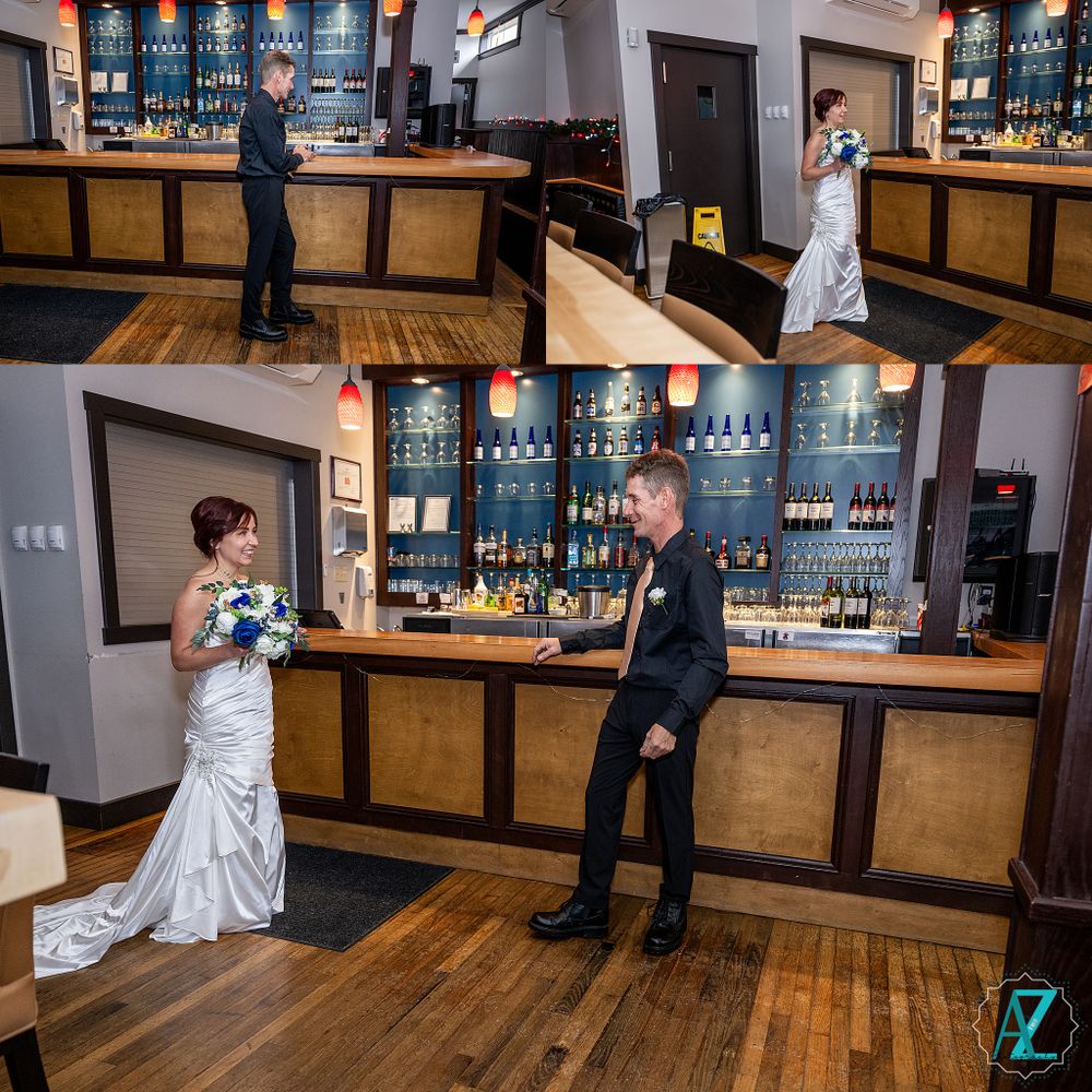 Wedding party poses at a stylish bar with wooden accents and blue-lit shelves displaying liquor bottles.