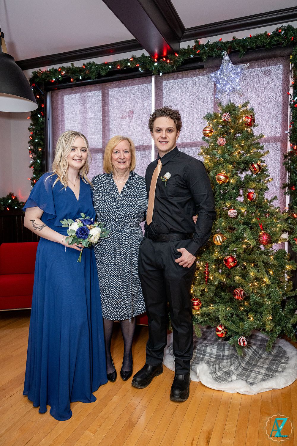 Holiday gathering with beautifully decorated Christmas tree and formal attire.