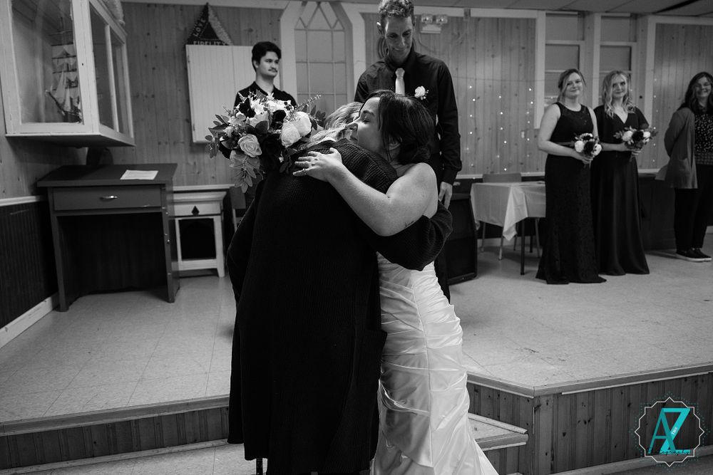 Black and white emotional moment during a wedding ceremony in a church setting.