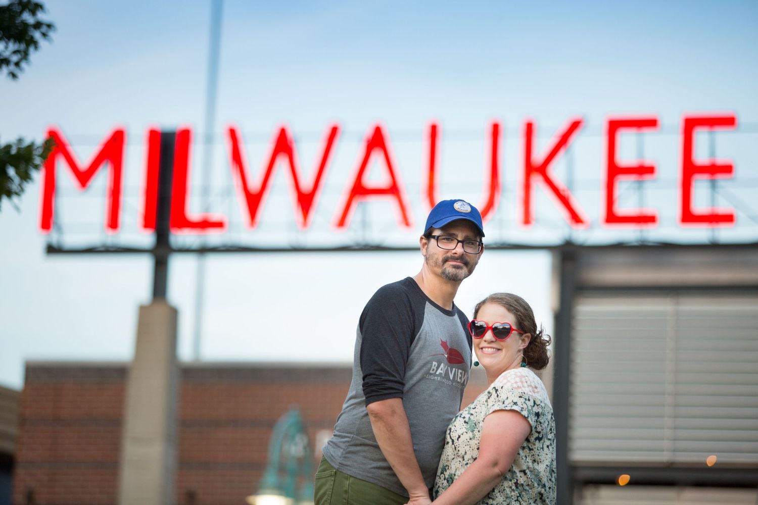 Couple hugging in front of Milwaukee Public Market by Meg Johnson Images