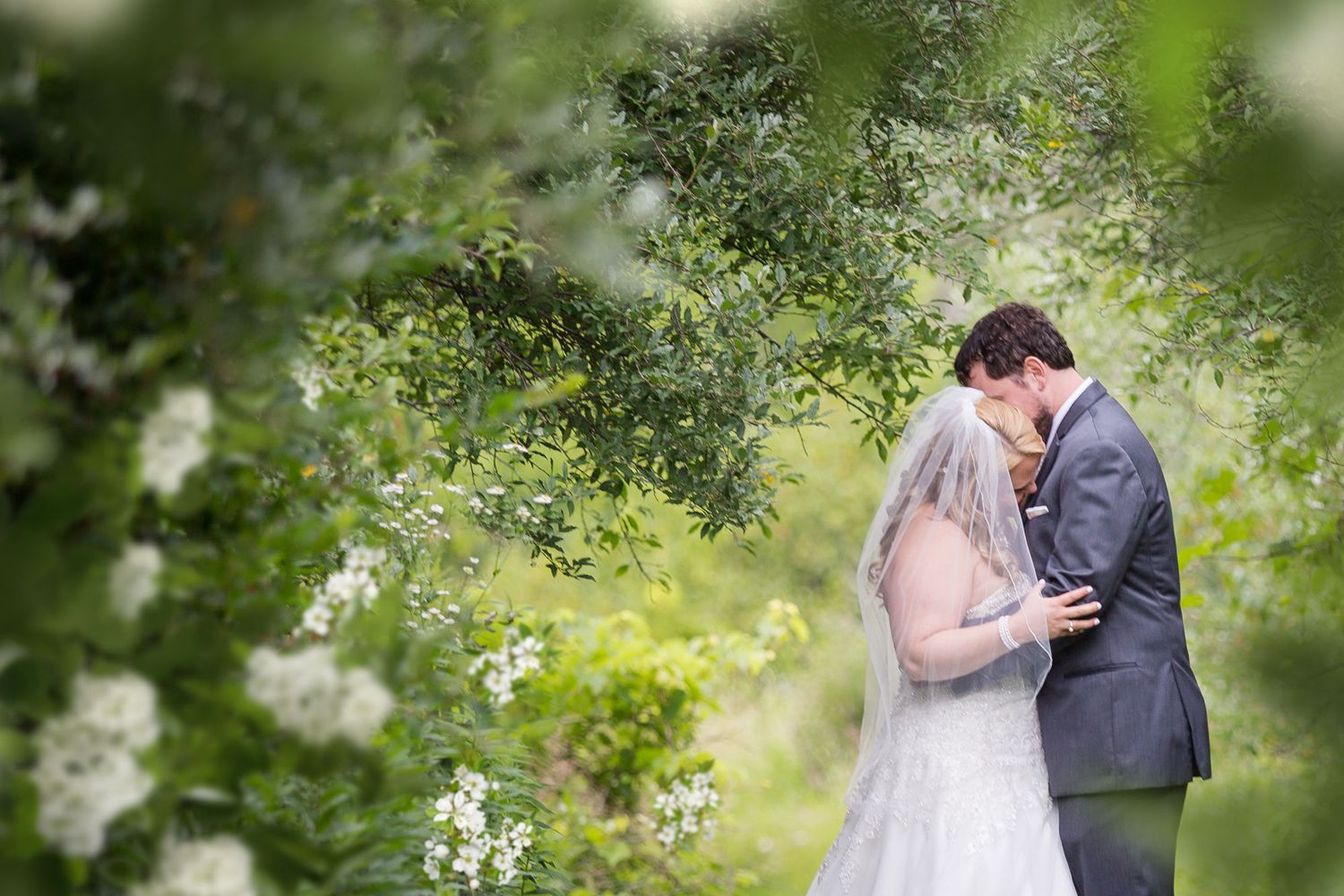Wedding couple surrounded by spring flowers in Ozaukee County Wisconsin by Meg Johnson Images