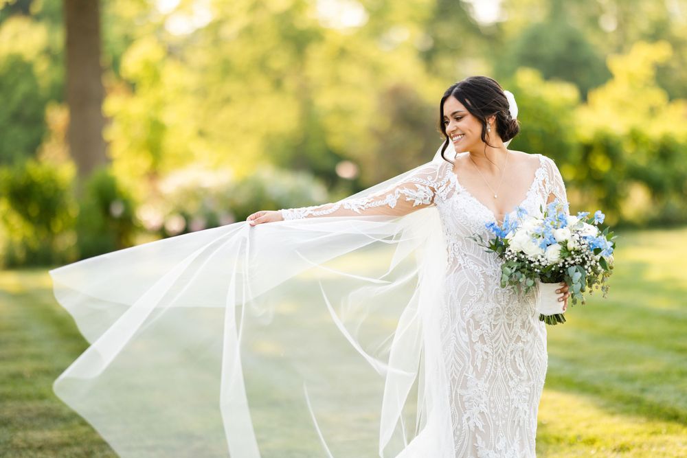 Brides veil blows in wind on wedding day at Jorgensen Farms in Westerville, Ohio.