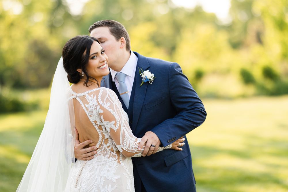 Groom kissing bride on wedding day at Jorgensen Farms in Westerville, Ohio.