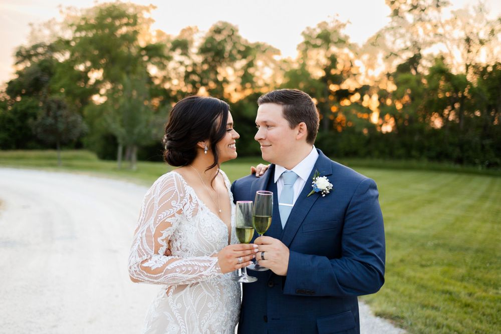 Newlyweds share champagne during sunset at Jorgensen Farms in Westerville, Ohio.