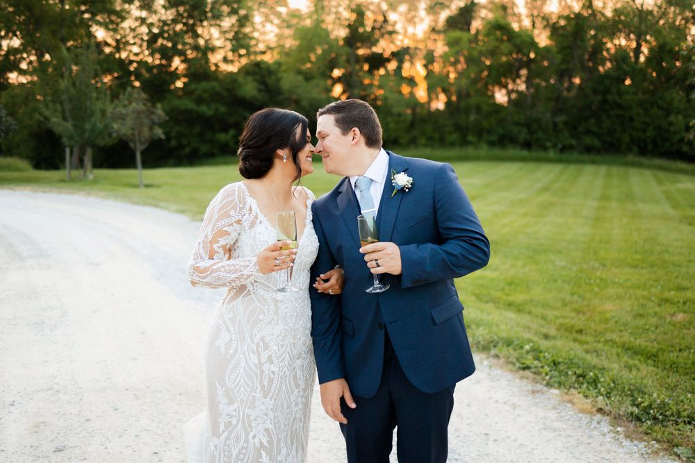 Bride and groom kissing during sunset wedding reception at Jorgensen Farms in Westerville, Ohio.