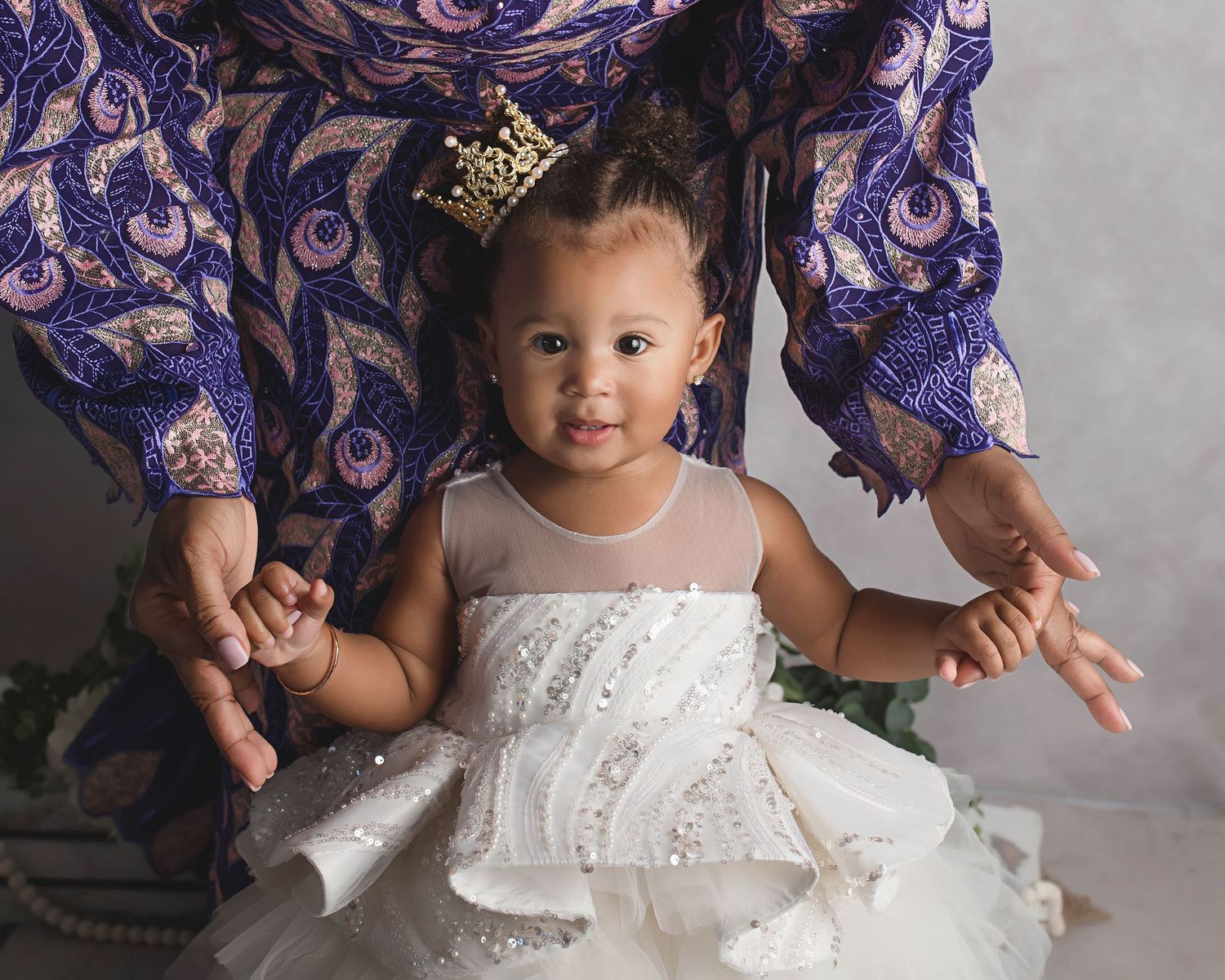 Portrait in white lace dress with traditional Nigerian formal wear details.