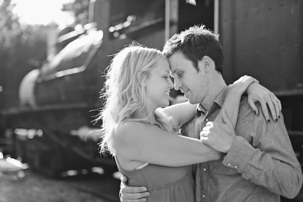 A tender black and white moment shared between a couple in natural lighting.