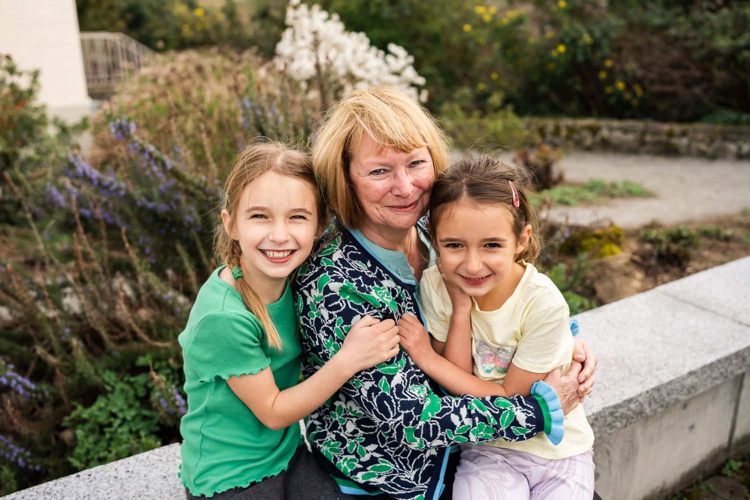 Grandmother hugging her granddaughters at Heritage Park.