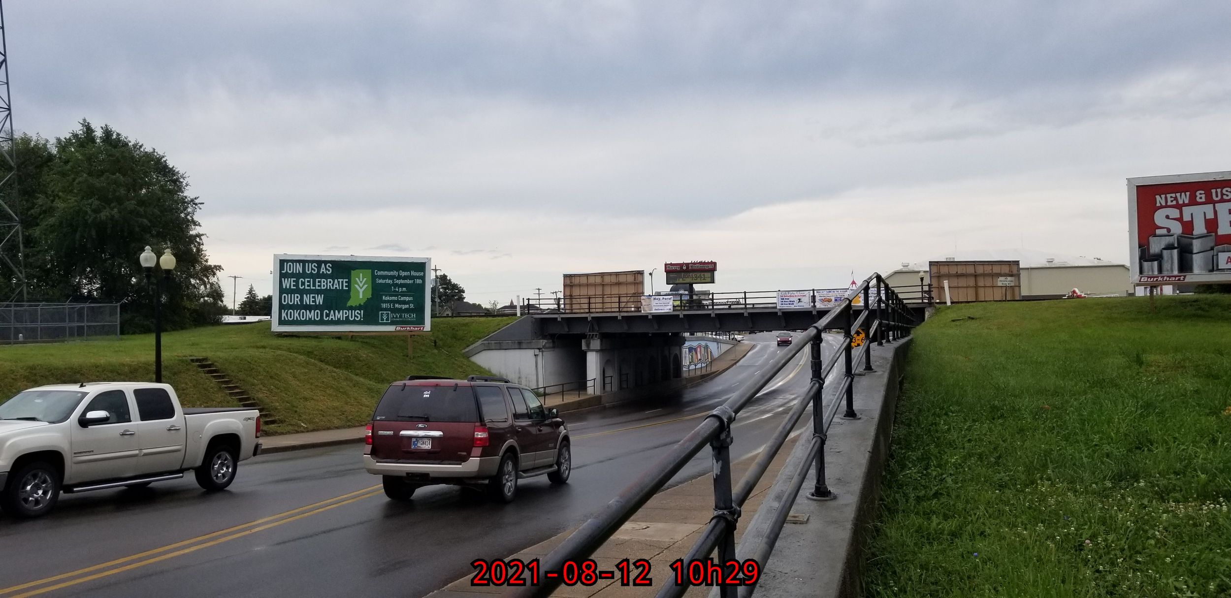 Highway view with multiple directional signs and vehicles.