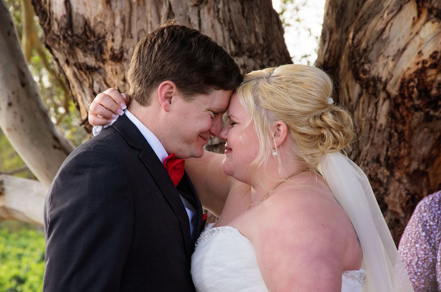 close up of bride and groom noses touching embracing close