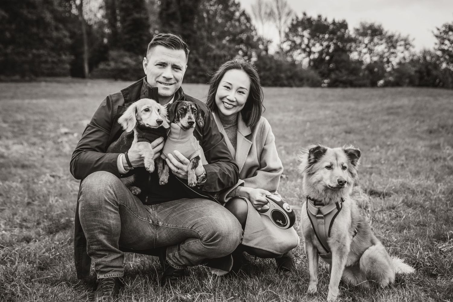 Couple with three dogs portrait