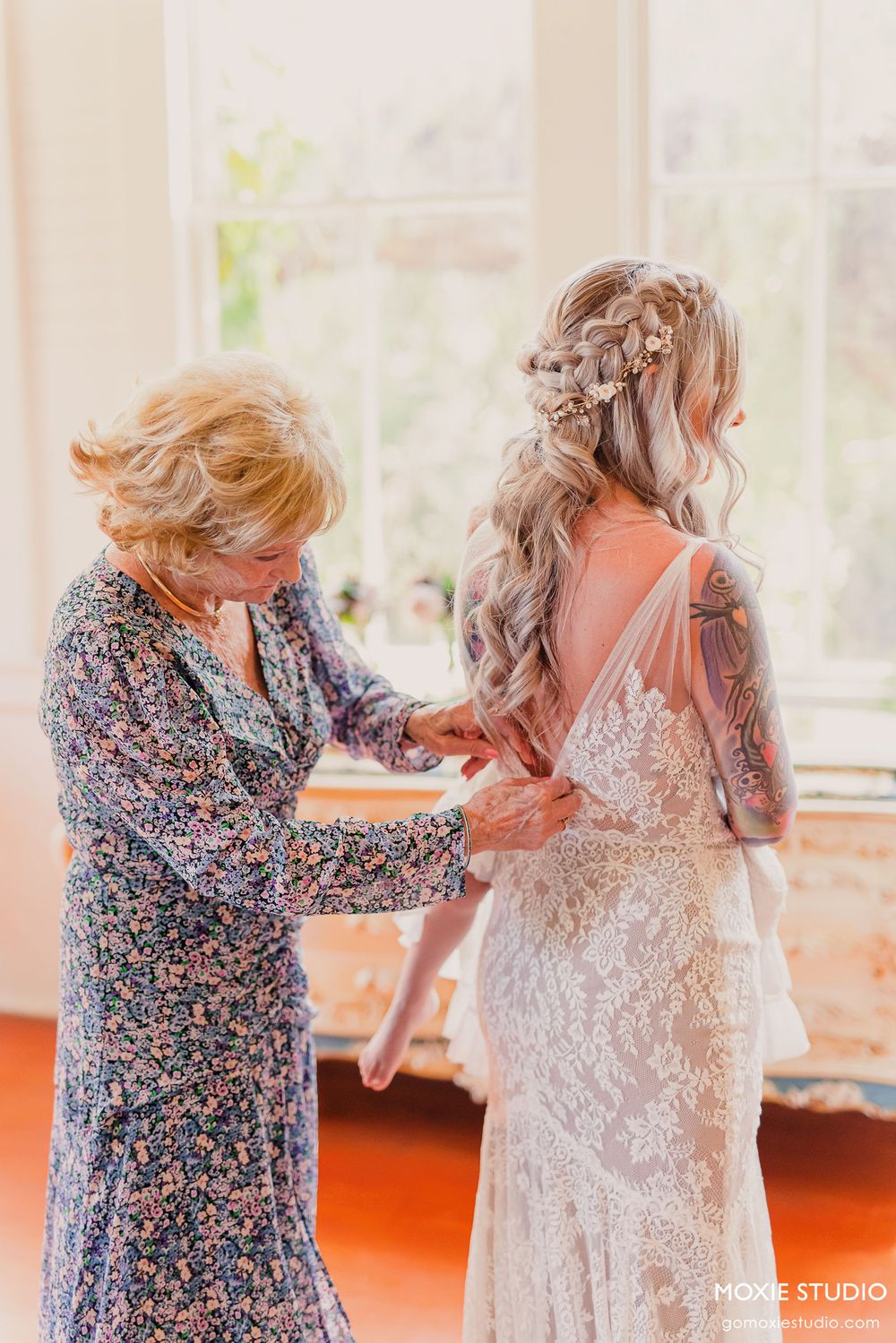 Wedding dress preparation sequence showing the intricate lace details being fastened.