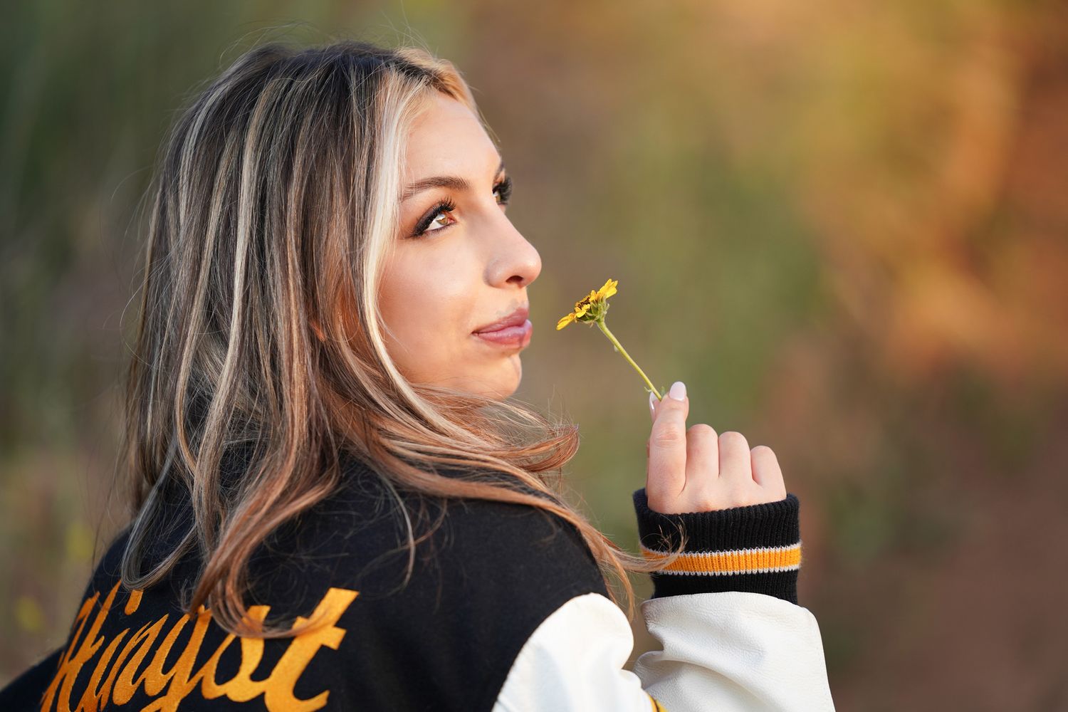margie-temme-captures-girl-in-letterman's-jacket-for-grad-photo