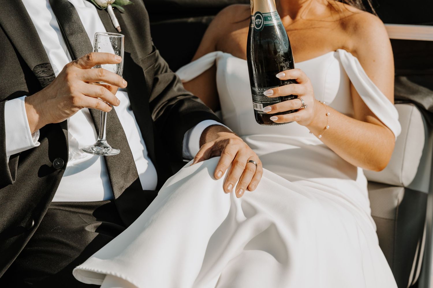 Close-up details of white wedding dress and formal attire.