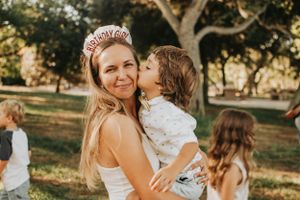 Joyful outdoor family moment captured in warm evening light.