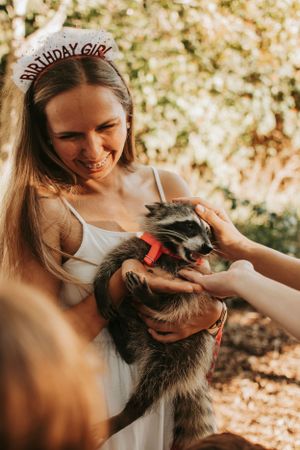 Playful moments with a gray cat during outdoor portrait session.