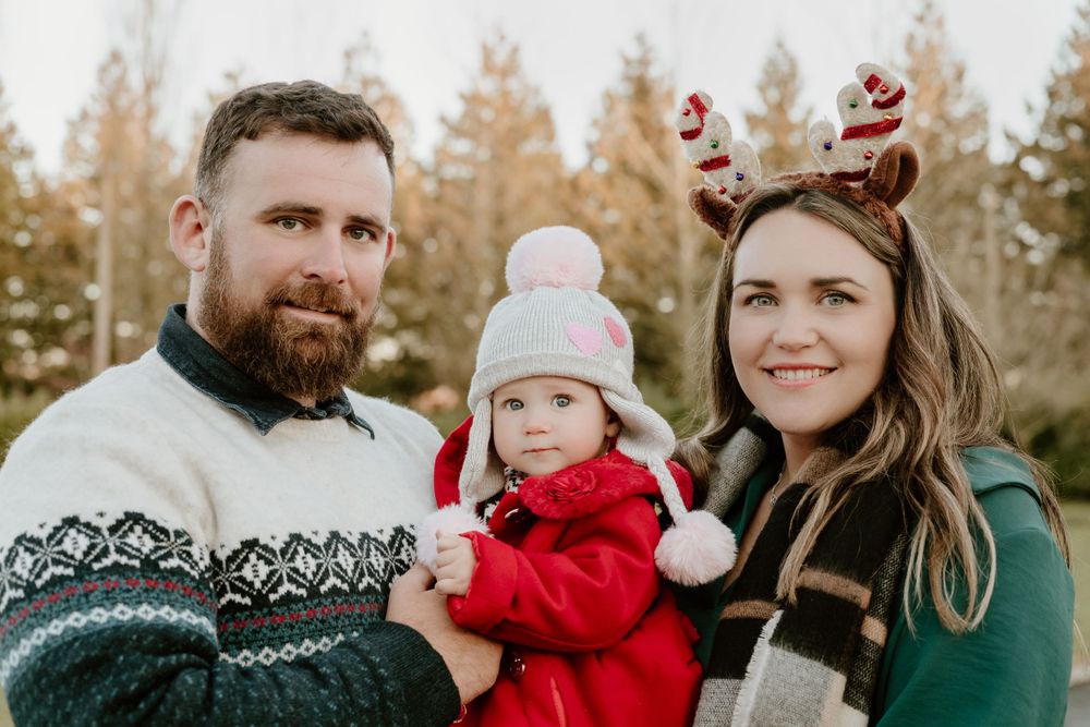 Outdoor Christmas photoshoot of mum dad and baby daughter