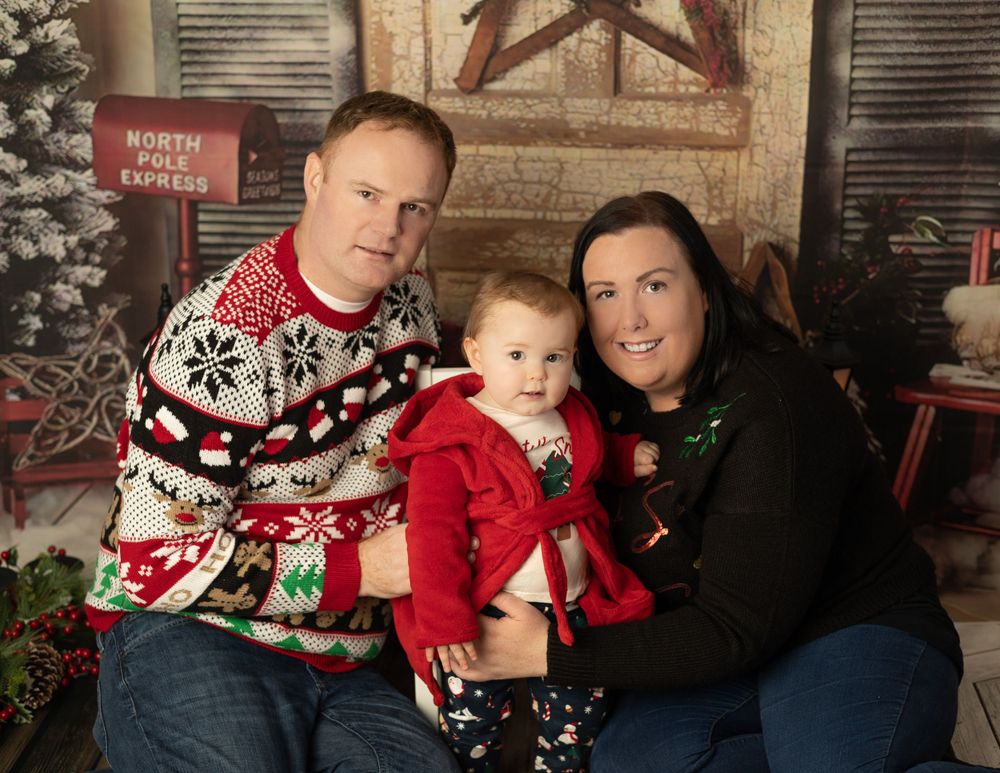 family Christmas photo with Christmas jumpers