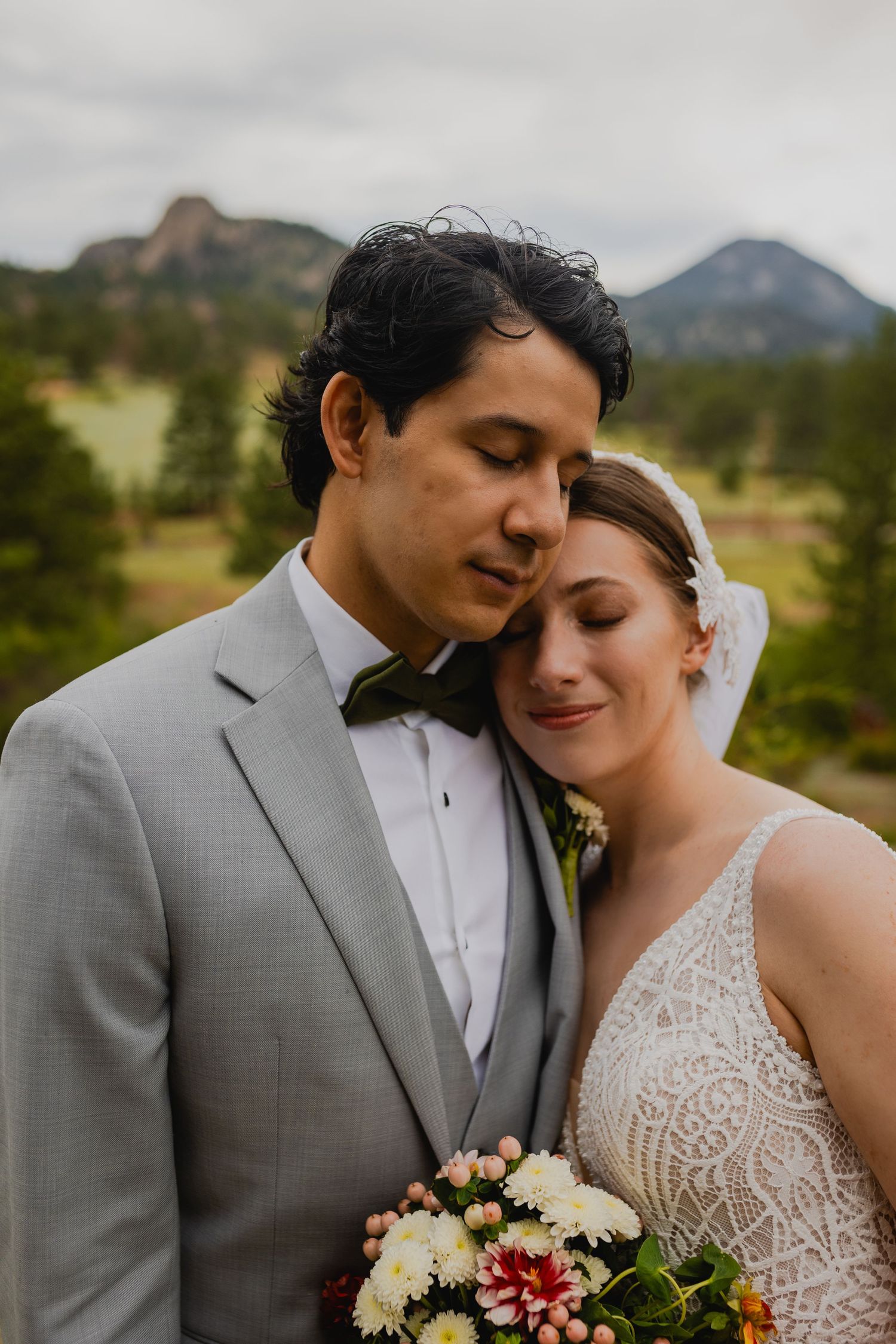Bride and groom sharing a loving embrace at The Black Canyon Inn in Estes Park