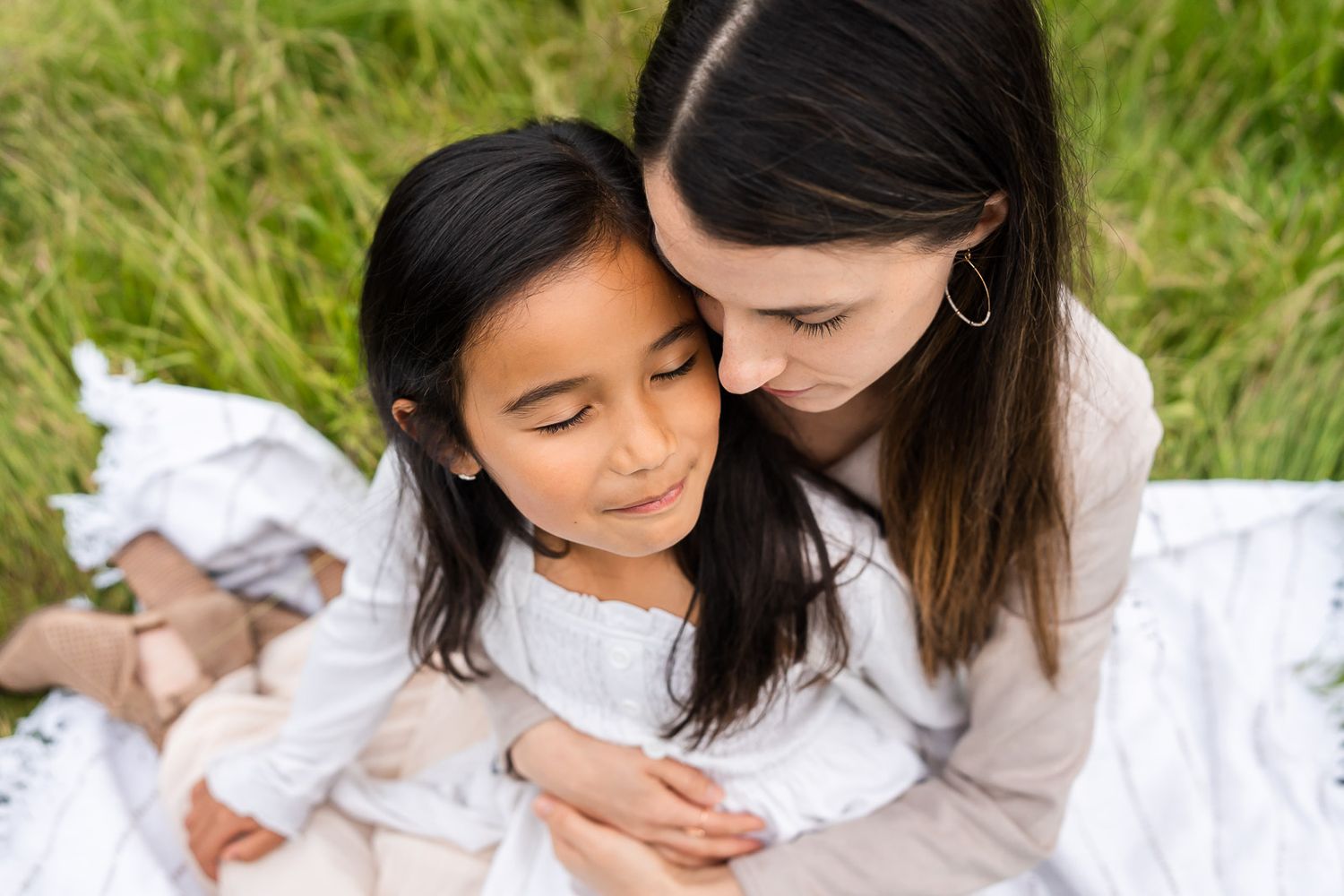 Mother hugging daughter in Kirkland