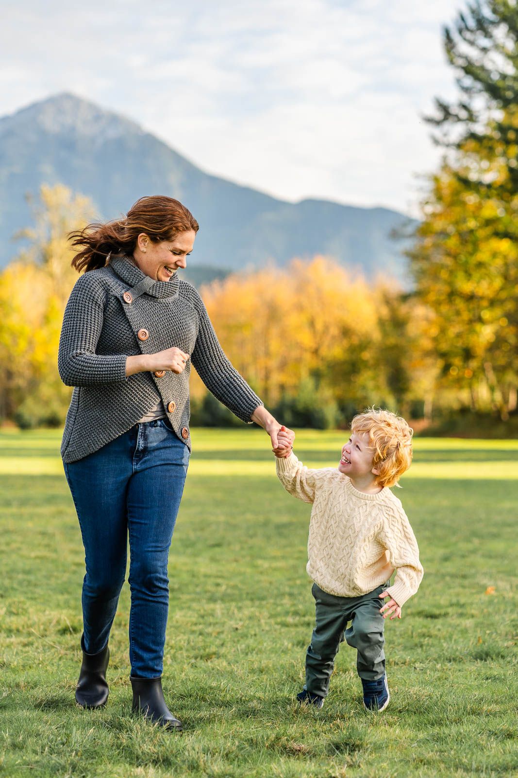 Mother and son hold hands while running in North Bend.