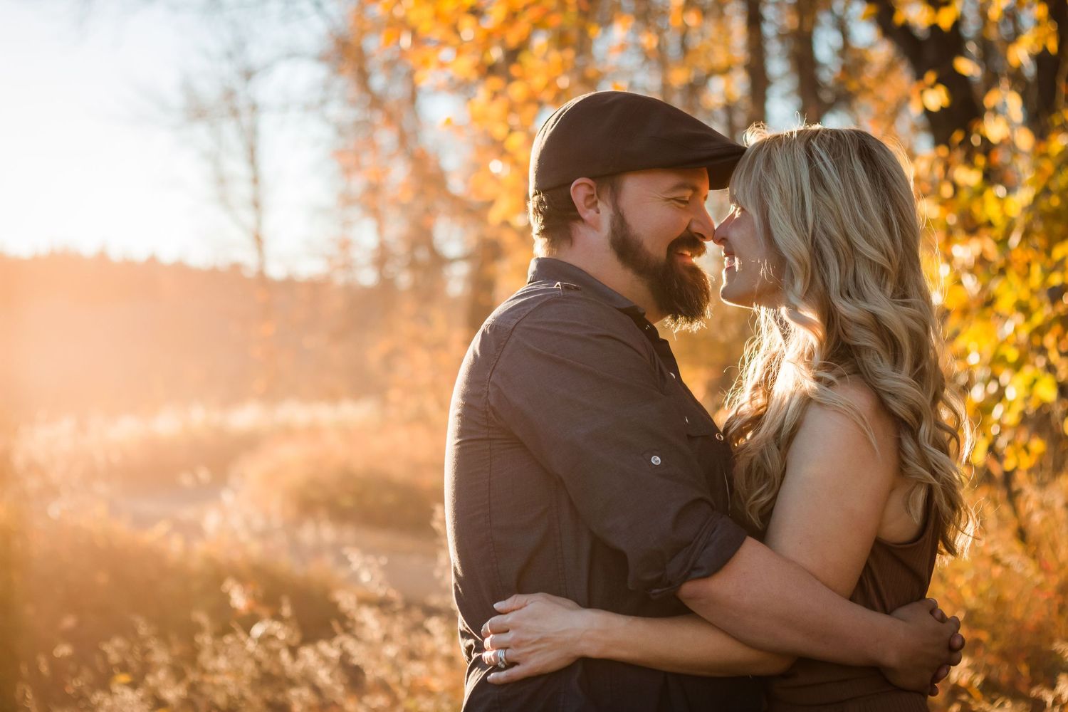 Fall photos in Calgary Alberta: Beautiful couples lifestyle photo session at golden hour in Fish Creek Park.
