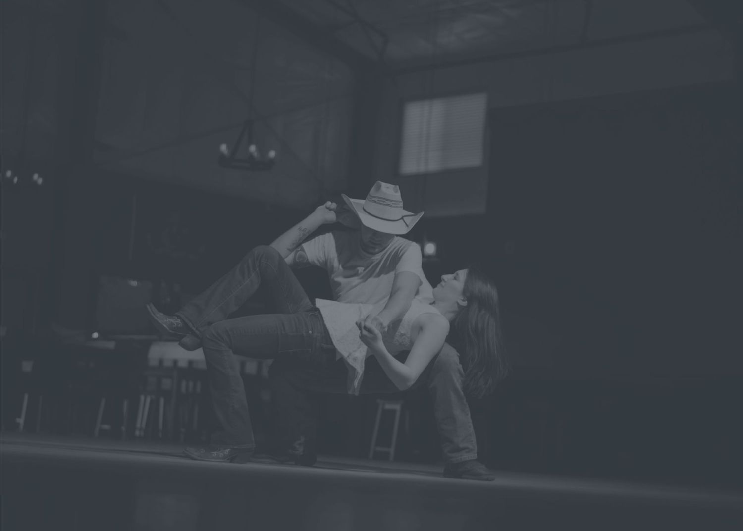 Couple country line dancing on stage