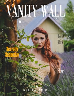 Vanity Wall Magazine May 2022 cover featuring a redhead woman in a yellow dress among garden foliage.